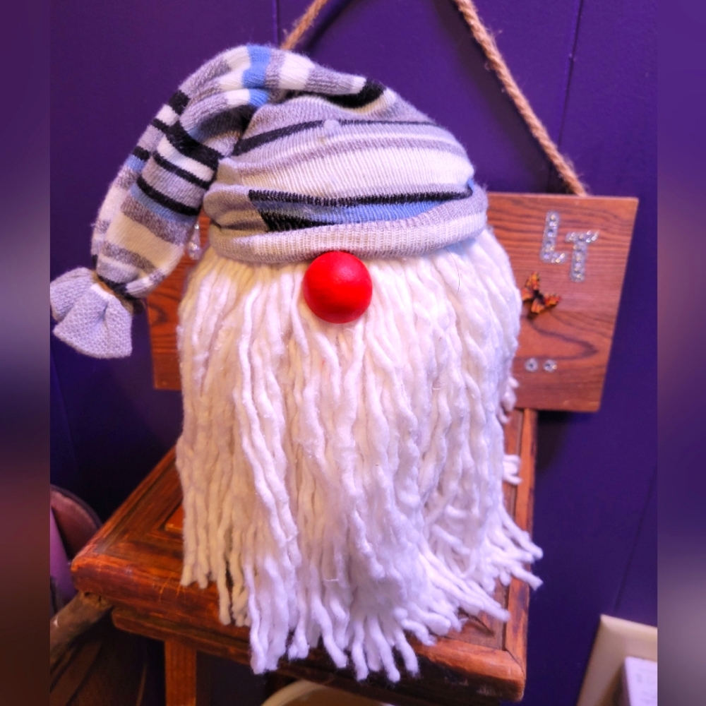 Handcrafted Mason jar gnome he has a red nose and striped hat and